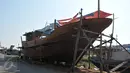 Sebuah badan kapal nelayan yang hampir jadi tampak terlihat di pinggir jalan kawasan Karangsong, Indramayu, Jabar, Rabu (17/6). Pembuatan kapal berkapasitas sekitar 30 grosstone tersebut dapat memakan biaya Rp 1-3 miliar. (Liputan6.com/Herman Zakharia)