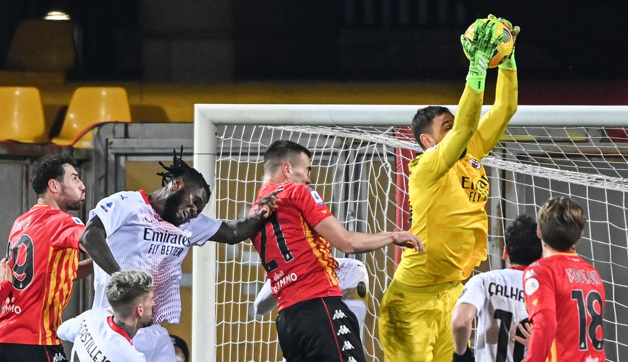 Kiper AC Milan, Gianluigi Donnarumma (kanan atas) melompat untuk menangkap bola dalam laga lanjutan Liga Italia 2020/21 pekan ke-15 melawan Benevento di Ciro-Vigorito, Minggu (3/1/2021). AC Milan menang 2-0 atas Benevento. (AFP/Andreas Solaro)