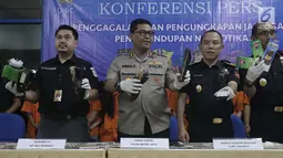 Petugas menunjukkan barang bukti penyelundupan kasus narkoba di Gedung Kantor Pos Pasar Baru, Jakarta, Senin (10/9). Barang bukti berupa 719,8 gram methampethamine, 50ribu butir ekstasi, 4 kg daun khat, 4 kg ketamine. (Liputan6.com/Immanuel Antonius)