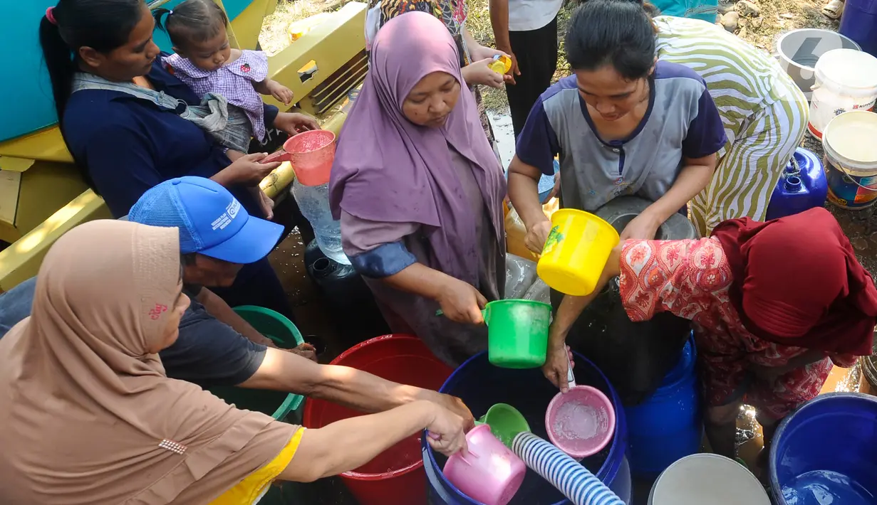 Warga terlihat menggunakan gayung masing-masing untuk mengambil air bersih secara rebutan. (merdeka.com/Arie Basuki)