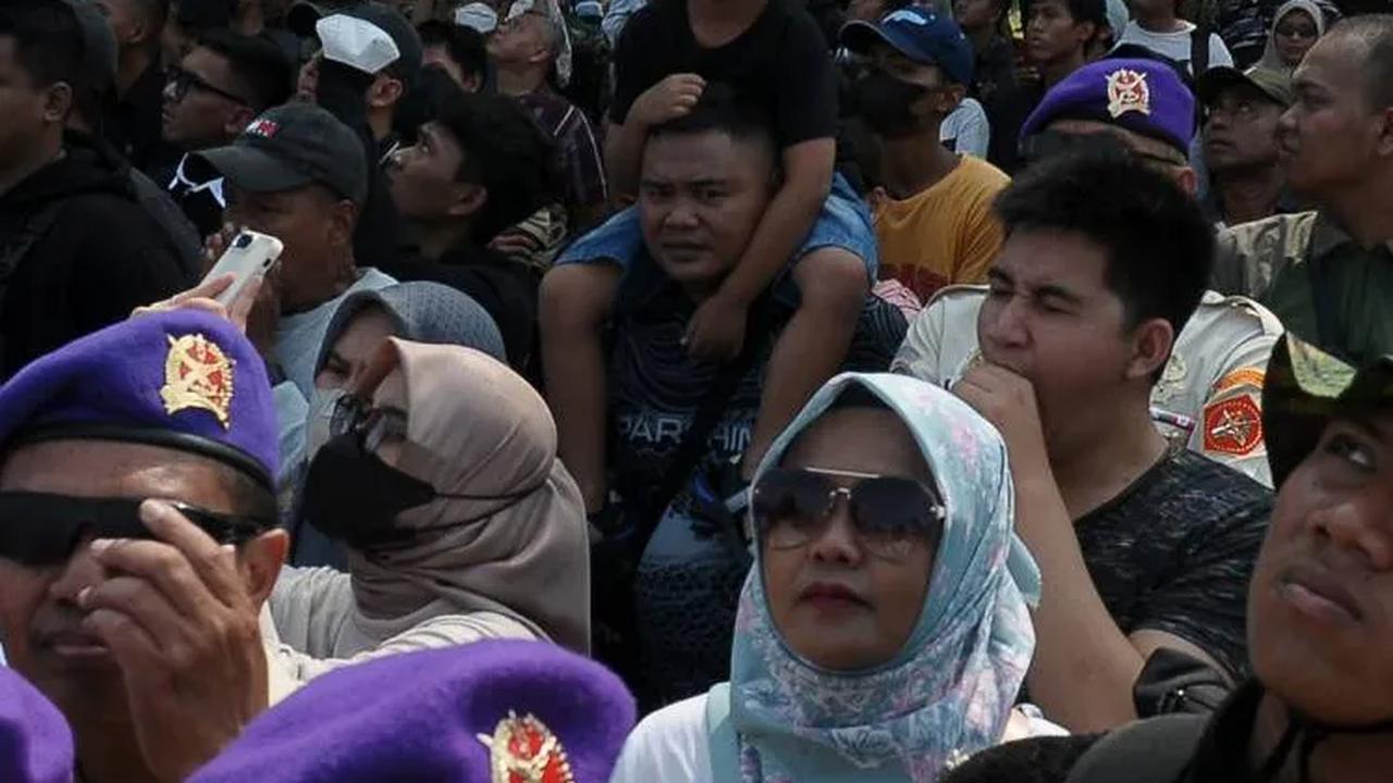 Antusiasme masyarakat saat menyaksikan atraksi terjun payung prajurit TNI AU, AL, AD dan juga perwakilan Polri.