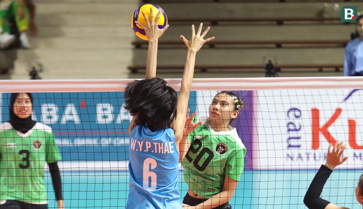 Pemain bola voli putri Indonesia, Shintia Alliva Mauludina (depan) melepaskan spike yang berusaha diblok pemain Myanmar pada laga ketiga Grup A SEA Games 2023 di Olympic Complex Indoor Stadium, Phnom Penh, Kamboja, Kamis (11/5/2023). Tim bola voli putri Indonesia menang 3-0 (25-9, 25-9, 25-15). (Bola.com/Abdul Aziz)