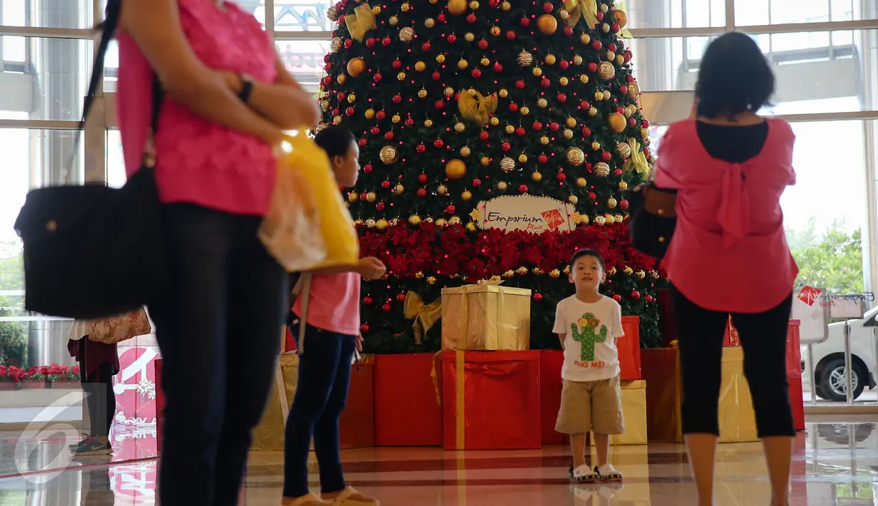 Pengunjung berfoto di dekat pohon natal di Emporium Pluit Mall, Jakarta Utara, Jumat (11/12/2015). Menyambut natal dan tahun baru 2016, Emporium Mall Pluit menyajikan aneka acara untuk menghibur para pengunjung. (Liputan6.com/Faizal Fanani)