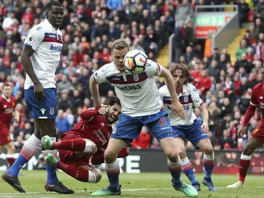 Pemain Liverpool, Mohamed Salah jatuh saat berebut bola dengan pemain Stoke city pada lanjutan Premier League di Anfield, Liverpool, (28/4/2018). Liverpool hanya bermain imbang 0-0 melawan Stoke City. (Martin Rickett/PA via AP)