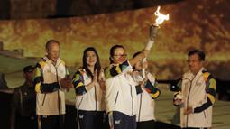 Pebulutangkis asal Yogyakarta, Kinarsih, saat prosesi kirab obor di Candi Prambanan, Rabu (18/7/2018). Api obor Asian Games tersebut akan dibawa mengelilingi 18 provinsi. (Bola.com/M Iqbal Ichsan)
