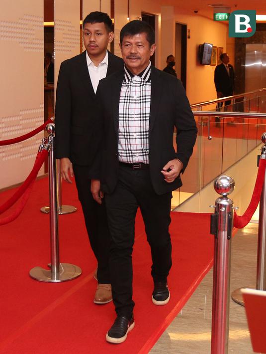 Pelatih kepala Timnas Indonesia U-22, Indra Sjafri berjalan di atas karpet merah pada sebuah acara yang berlangsung di Hotel JS Luwansa, Kuningan, Jakarta, Rabu (19/07/2023). Coach Indra terlihat mengenakan jas hitam dipadukan dengan kemeja bermotif kotak-kotak. (Bola.com/Bagaskara Lazuardi)