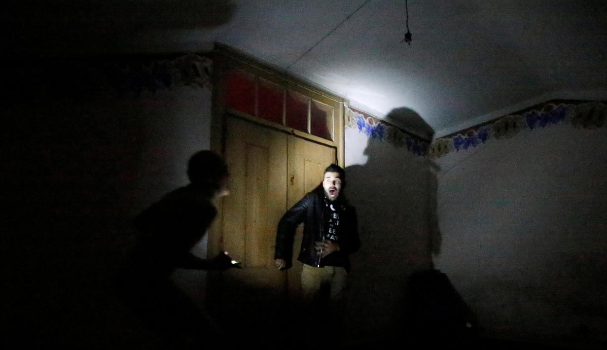 Ekspresi pengunjung saat ketakutan menemui hantu di Quinta Nova da Assuncao, Belas, Portugal (13/5). Rumah hantu ini berisi 25 kamar dipenuhi penampakan bayangan dan suara dari pintu yang menutup secara acak. (REUTERS/Rafael Marchante)