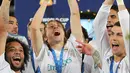 Gelandang Real Madrid, Luka Modric (tengah) mengangkat trofi Piala Dunia Antarklub 2017 di stadion Zayed Sports City di Abu Dhabi, Uni Emirat Arab, (16/12). Madrid sukses mengalahkan Gremio 1-0 berkat gol Cristiano Ronaldo. (AFP Photo / Karim Sahib)