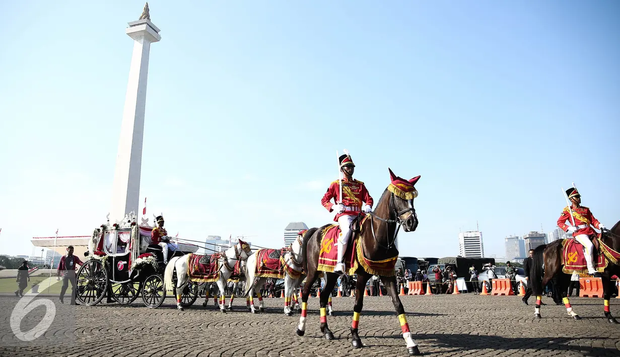 Pasukan berkuda mengiringi pembawa duplikat bendera pusaka dari Monumen Nasional menuju Istana di Jakarta, Rabu (17/8). Kegiatan tersebut dalam rangka memperingati HUT RI ke-71. (Liputan6.com/Faizal Fanani)