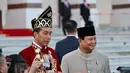 Jokowi dan Iriana Jokowi mengenakan baju adat Banjar yang Bernama Baamar Galung Pancar Matahari. [Foto: Instagram/kemhanri]