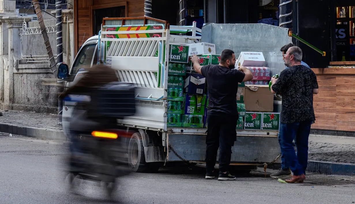Seorang pria mengantarkan bir ke sebuah toko minuman keras di Baghdad, Irak, 9 Maret 2023. Aturan tentang larangan minuman beralkohol di Irak mengutip Undang-Undang Impor Dalam Negeri 2023 yang melarang impor, produksi, dan penjualan minuman beralkohol. (AP Photo/Hadi Mizban)