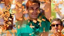Petenis Swiss, Roger Federer mengangkat tropi usai memenangkan pertandingan pada final Miami Terbuka di Crandon Park, Florida (2/4). Federer menundukkan rival lamanya, Rafael Nadal dua set langsung 6-3, 6-4. (AP Photo/Wilfredo Lee)
