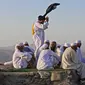 Peziarah muslim berfoto di Jabal al-Noor atau Gunung Cahaya yang menghadap ke Kota Suci Mekkah, Arab Saudi, 5 Juli 2022. Satu juta orang, termasuk 850 ribu dari luar negeri, diizinkan untuk berpartisipasi dalam haji tahun ini setelah dua tahun terakhir jumlahnya dikurangi secara drastis karena pandemi virus corona COVID-19. (Christina ASSI/AFP)