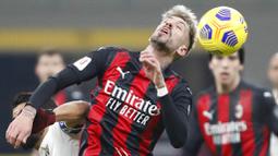 Pemain AC Milan, Samu Castillejo, menyundul bola saat melawan Torino pada laga Coppa Italia di Stadion San Siro, Selasa (12/1/2021). AC Milan menang adu penalti dengan skor 5-4. (AP/Antonio Calanni)