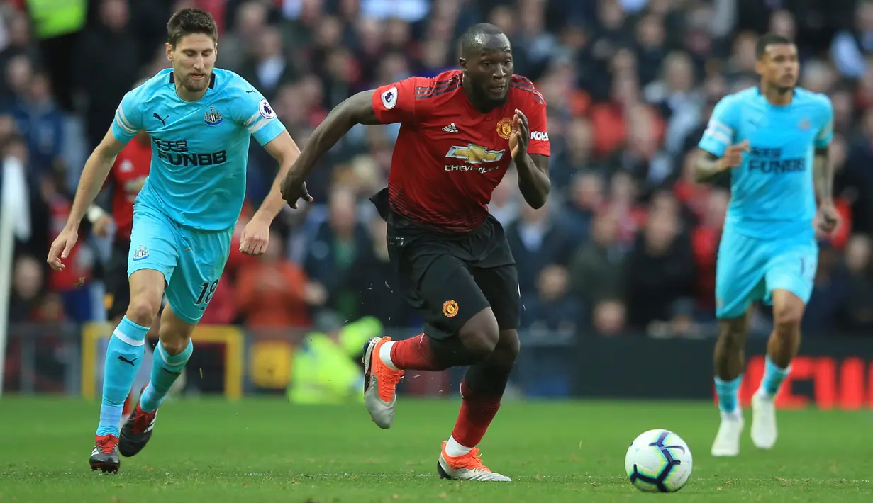 Striker Manchester United, Romelu Lukaku mengiring bola dari kejaran pemain Newcastle United Federico Fernandez saat bertanding pada lanjutan Liga Inggris di stadion Old Trafford (6/10). MU menang tipis atas Newcastle 3-2. (AP Photo/Jon Super)