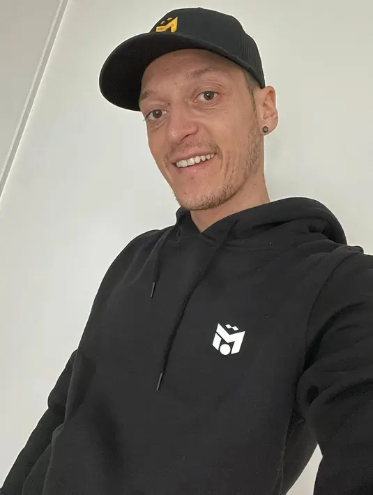 <p>Atau di sini Mezut Ozil tampil dengan hoodie hitam yang berasal dari brandnya sendiri, lengkap dengan capnya. Foto: Instagram.</p>
