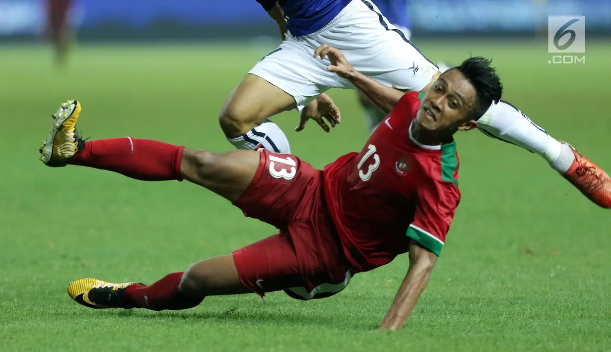 Gelandang Timnas Indonesia, Febri Haryadi terjatuh saat berebut bola dengan pemain Kamboja pada laga persahabatan di Stadion Patriot Candrabhaga, Bekasi, Rabu (4/10). Timnas Indonesia menang 3-1. (Liputan6.com/Helmi Fithriansyah)