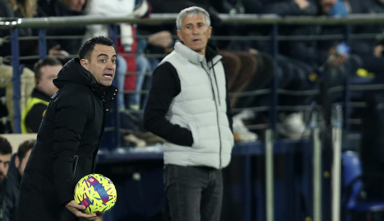 Pelatih Barcelona, Xavi Hernandez memberikan instruksi kepada para pemainnya saat bertanding melawan Villarreal selama pertandingan lanjutan La Liga Spanyol di stadion Ceramica di Villarreal, Spanyol, Senin (13/2/2023). Kemenangan ini membuat Barcelona makin kokoh di puncak klasemen. (AP Photo/Alberto Saiz)
