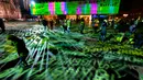 Sejumlah pengunjung menikmati instalasi cahaya jelang pergantian tahun di Cologne, Jerman (31/12). Instalasi cahaya tersebut berbentuk macam-macam tulisan yang berkilauan. (AFP/Patrik Stollarz)