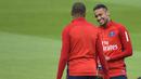 Pemain baru Paris Saint-Germain, Kylian Mbappe, berbincang dengan Neymar Jr, saat sesi latihan di Paris, Rabu (6/9/2017). Striker 18 tahun tersebut menjalani latihan perdananya bersama armada Les Parisiens. (AFP/Christophe Simon)