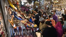 Orang-orang memadati area pasar saat berbelanja di sebuah pasar di Lahore, Pakistan (4/5/2021). Di tengah pandemi virus corona Covid-19, sejumlah warga memadati area pasar tersebut menjelang hari Idul Fitri. (AFP/Arif Ali)