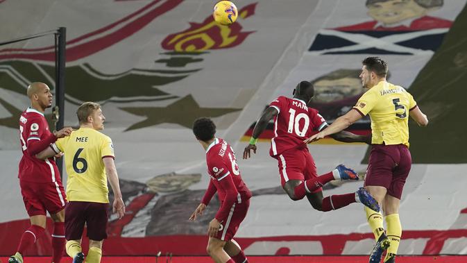 James Tarkowski dari Burnley, kanan, menyundul bola selama pertandingan sepak bola Liga Premier Inggris antara Liverpool dan Burnley di Liverpool, Inggris, Kamis, 21 Januari 2021. (Foto AP / Jon Super, Pool)