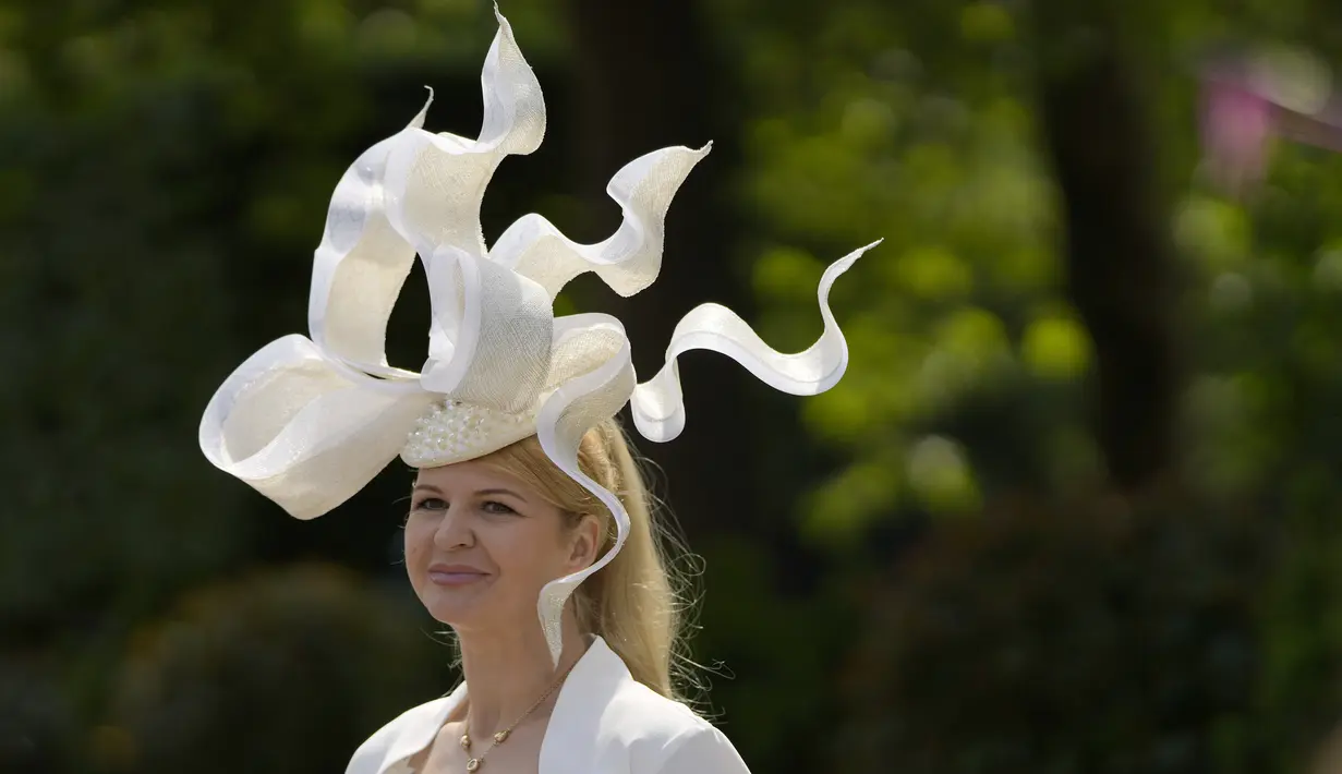 Seorang penonton tiba dengan mengenakan pakaian berornamen pada hari pertama pacuan kuda Royal Ascot di Ascot, Inggris, Selasa (15/6/2021). Balap kuda eksklusif yang hanya dihadiri oleh kalangan elit Inggris itu menjadi tradisi tahunan sejak tahun 1711. (AP Photo/Alastair Grant)