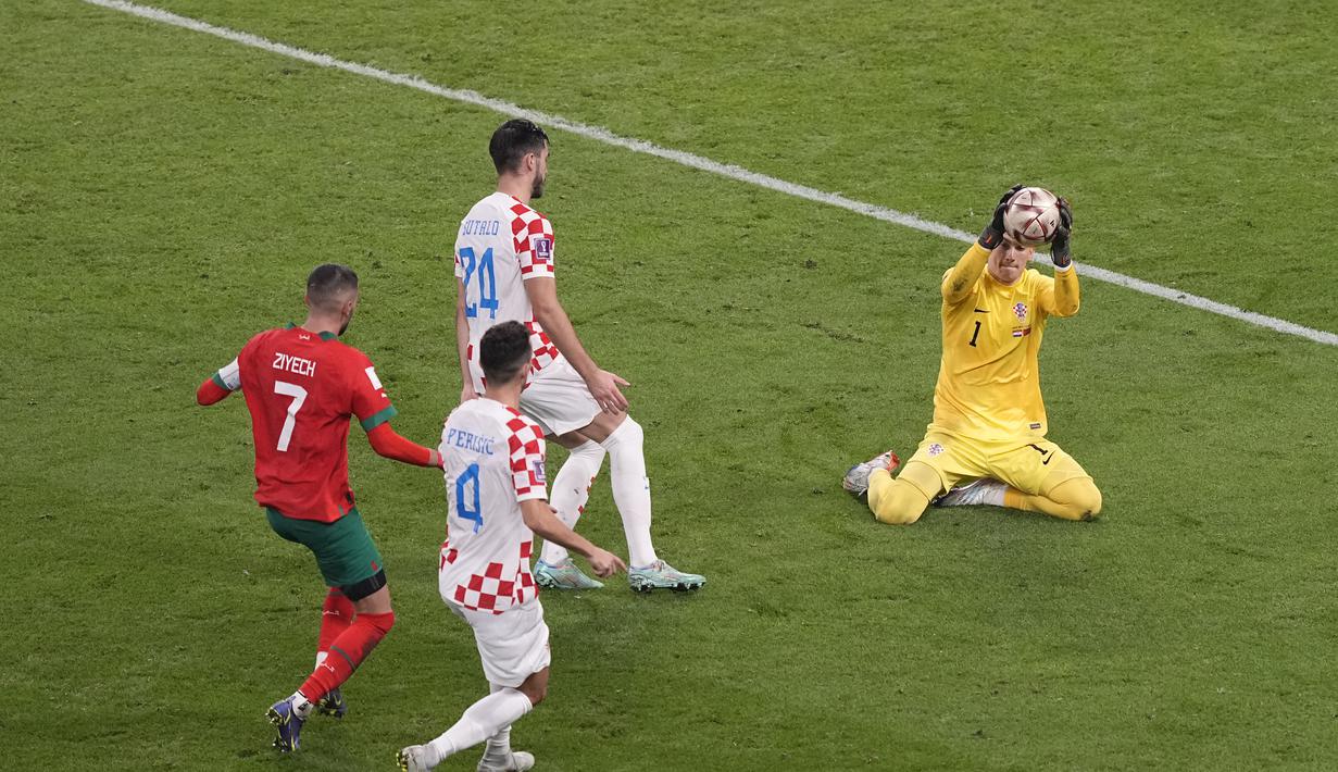 Kiper Kroasia Dominik Livakovic melakukan penyelamatan saat bertanding melawan Maroko pada pertandingan playoff perebutan peringkat ketiga Piala Dunia 2022 di Khalifa International Stadium di Doha, Qatar, Sabtu (17/12/2022). Kroasia meraih juara ketiga Piala Dunia 2022 usai menang 2-1 atas Maroko. (AP Photo/Martin Meissner)