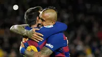 Arturo Vidal memeluk Lionel Messi usai mencetak gol ke gawang Granada pada lanjutan La Liga 2019/2020. Dalam duel ini, Barcelona menang 1-0 (LLUIS GENE / AFP)