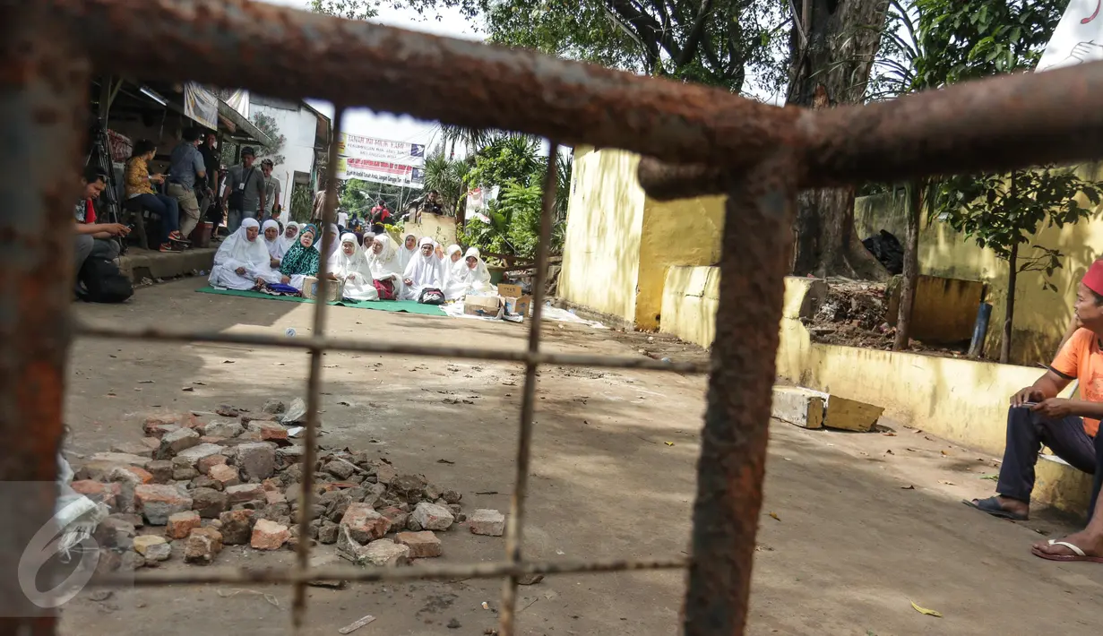 Sejumlah ibu-ibu menggelar doa bersama di lokasi, RT 1 RW 12, Jl Saharjo, Manggarai, Jakarta, Rabu (26/4). Mereka menolak penggusuran rumahnya oleh PT KAI yang akan dibangun Double Double Track (DDT) Manggarai-Soekarno Hatta. (Liputan6.com/Faizal Fanani)