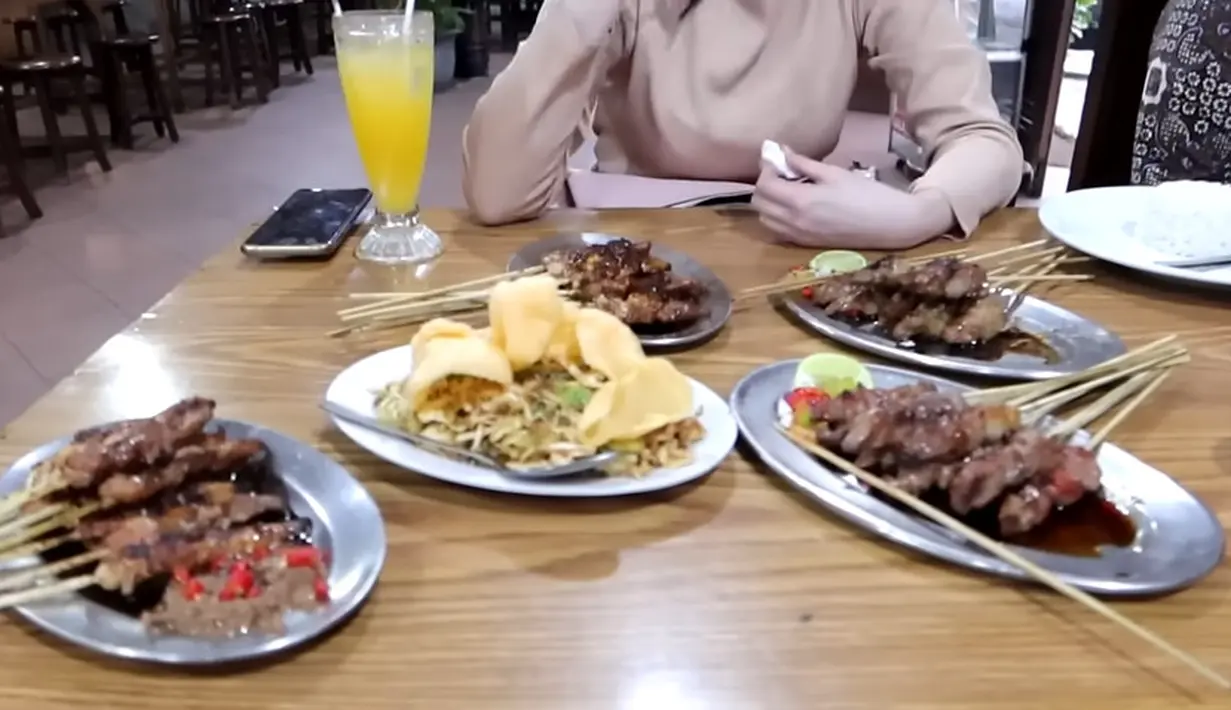 Momen tersebut dibagikan melalui kanal vlog Youtubenya. Tempat pertama yang dikunjungi adalah sate yang menjadi langganan keluarganya yang berada di Jl Raya Pasar Minggu. Selain sate tanpa lemak, menyediakan karedok hingga gule.[Youtube/arumibachsin_94]