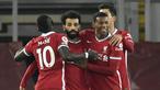 Gelandang Liverpool, Mohamed Salah (tengah), melakukan selebrasi usai mencetak gol pertama Liverpool ke gawang Wolverhampton dalam laga lanjutan Liga Inggris 2020/21 pekan ke-11 di Anfield Stadium, Minggu (6/12/2020). Liverpool menang 4-0 atas Wolverhampton. (Pool via AFP/Peter Powell)