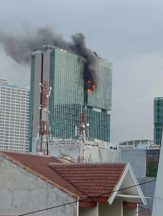 Kobaran api terlihat dari gedung Swiss-Belhotel di daerah Kelapa Gading, Jakarta Utara, Minggu (7/8/2016). Bagian atas gedung tersebut terbakar dan hingga kini sedang dipadamkan. (Istimewa)