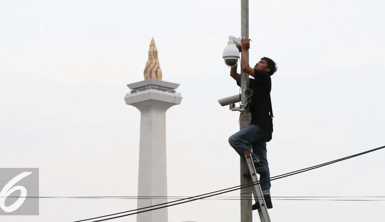 Pekerja memasang CCTV di Kawasan Monumen Nasional, Jakarta, Kamis (3/11). Pemasangan CCTV tersebut untuk meningkatkan keamanan di sekitar Monas. (Liputan6.com/Gempur M Surya)