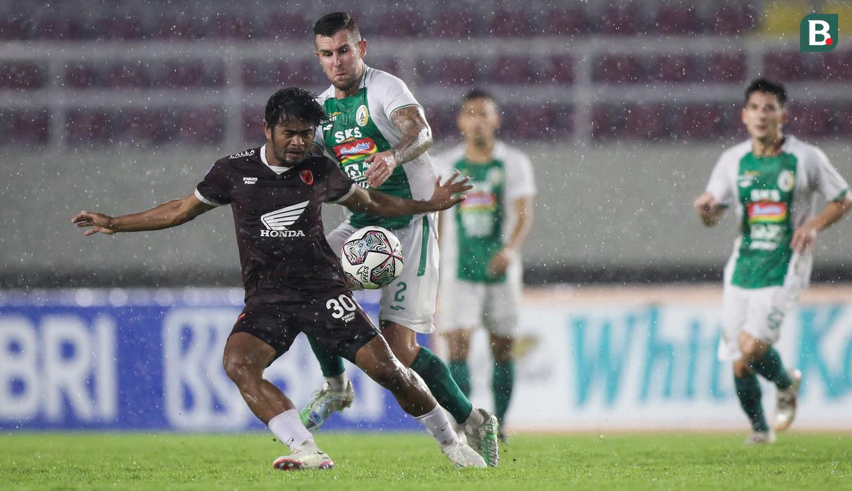 Pemain PSM Makassar, Ilham Udin Armaiyn (kiri) berebut bola dengan pemain PSS Sleman, Aaron Michael Evans dalam laga pekan ke-12 BRI Liga 1 2021/2022 di Stadion Manahan, Solo, Kamis (18/11/2021). (Bola.com/Bagaskara Lazuardi)