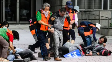 Pegawai kantor distrik mengenakan rompi visibilitas tinggi saat mereka membantu menolong korban selama simulasi latihan anti-teror, di Seoul, Korea Selatan pada tanggal 20 Agustus 2024. (ANTHONY WALLACE/AFP)