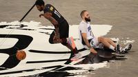 Pebasket Brooklyn Nets, Kyrie Irving lewati adangan pemain Orlando Magic pada laga lanjutan NBA 2020/2021, Jumat pagi WIB. (AL BELLO / GETTY IMAGES NORTH AMERICA / Getty Images via AFP)