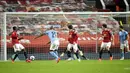 Pemain Manchester City Riyad Mahrez mencetak gol ke gawang Manchester United pada pertandingan semifinal Piala Liga Inggris di Old Trafford, Manchester, Inggris, Rabu (6/1/2021). Manchester City melaju ke final Piala Liga Inggris usai mengalahkan MU 2-0. (Peter Powell/Pool via AP)