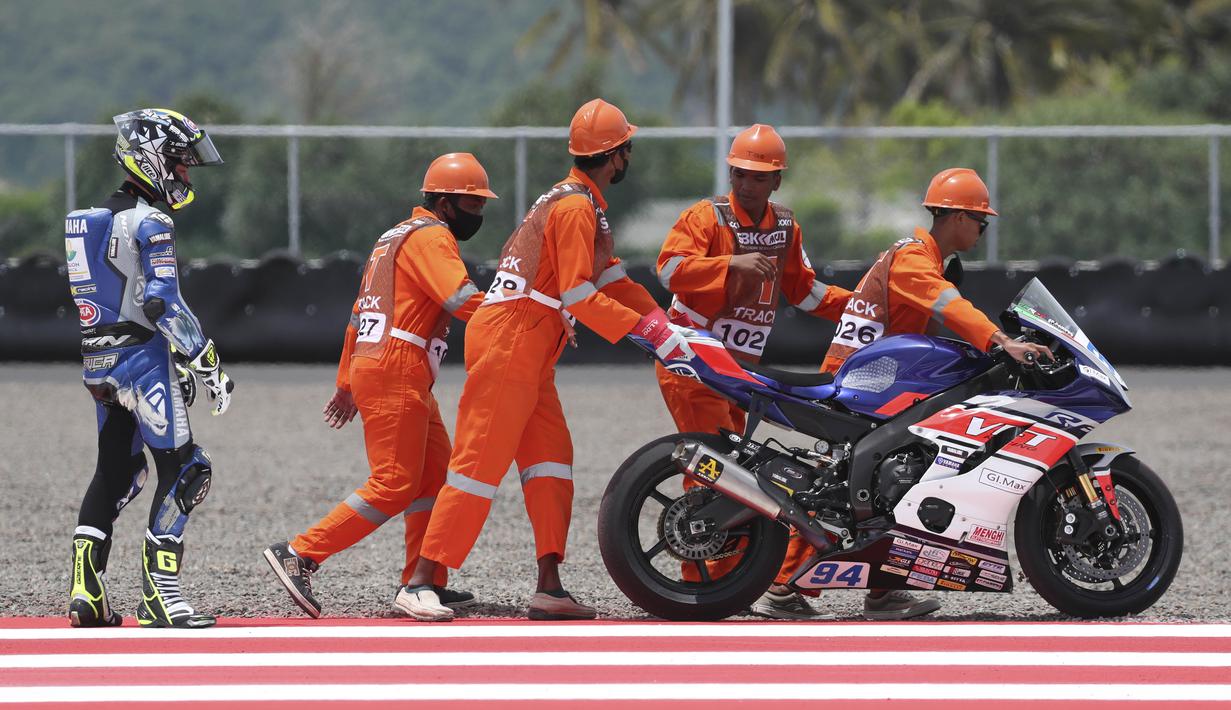 Sejumlah Marshall membantu pembalap Tim VFT Racing Federico Caricasulo setelah mengalami masalah mesin saat latihan bebas World Superbike di Sirkuit Internasional Mandalika, Lombok. (AP Photo/Achmad Ibrahim)