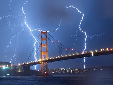 Kilatan petir terlihat di atas jembatan Golden Gate di San Francisco, California, AS (11/9). Petir merupakan Gejala alam yang biasanya muncul pada musim hujan di saat langit memunculkan kilatan cahaya sesaat yang menyilaukan. (AFP Photo/Josh Edelson)