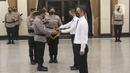 Kapolri Jenderal Polisi Listyo Sigit Prabowo menyerahkan surat pengangkatan kepada perwakilan mantan pegawai KPK saat pelantikan di Mabes Polri, Jakarta, Kamis (9/12/2021). Sebanyak 44 mantan pegawai KPK mengikuti pelantikan menjadi Aparatur Sipil Negara (ASN) Polri. (Liputan6.com/Herman Zakharia)
