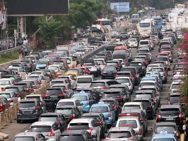Sejumlah kendaraan terjebak kemacetan panjang di tol yang mengarah ke Bandara Soekarno-Hatta (Soetta), Tangerang, Banten, Selasa (10/11/2020). Kemacetan terjadi karena adanya penyambutan kepulangan pimipinan Front Pembela Islam (FPI) Rizieq Shihab. (Liputan6.com/Angga Yuniar)