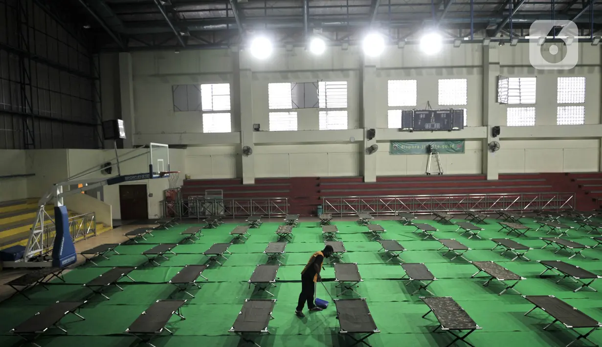 Petugas membersihkan ruang karantina pemudik di Gelanggang Remaja Pulogadung, Rawamangun, Jakarta, Kamis (28/5/2020). Gelenggang ini dijadikan lokasi karantina bagi pemudik atau pendatang yang tidak memiliki SIKM saat tiba di Ibu Kota via bus AKAP. (merdeka.com/Iqbal S. Nugroho)