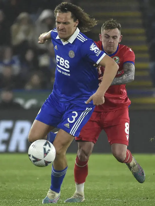 Gelandang Blackburn Rovers, Sammie Szmodics berebut bola dengan bek Leicester City Wout Faes pada laga putaran ke-5 Piala FA 2022/2023 di Stadion King Power, Rabu (1/3/2023), dini hari WIB. Menjamu Blackburn Rovers, tim tuan rumah Leicester City gagal untuk menambah gol lagi dan harus tersingkir dari Piala FA di babak kelima.  (AP Photo/Rui Vieira)