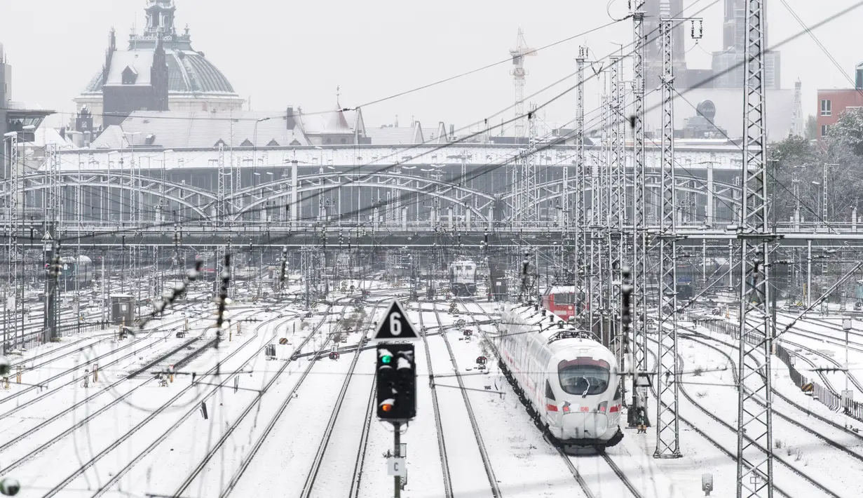 Suasana di stasiun utama kereta api di Munich yang terturup salju, Jerman (18/4). Hujan salju yang melanda kawasan ini tidak menyurutkan warga untuk tetap beraktivitas. (AFP PHOTO / dpa / Matthias Balk / Jerman OUT)