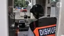 Petugas parkir bekerja dalam ruangannya di IRTI Monas, Jakarta, Rabu (15/2/2023). Penerapan tarif disinsentif (tarif parkir tertinggi) berdasarkan Pergub Provinsi DKI Jakarta Nomor 66 Tahun 2020 Tentang Uji Emisi Gas Buang Kendaraan Bermotor. (merdeka.com/Iqbal S. Nugroho)