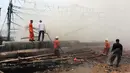 Sejumlah petugas pemadam kebakaran tampak berada di lokasi tempat kapal terbakar di Pelabuhan Muara Angke, Jakarta, Jumat (27/2/2015). Diduga kebakaran disebabkan korsleting listrik. Kerugian ditaksir mencapai ratusan juta. (Liputan6.com/Johan Tallo)