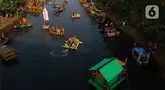 Pemerintah Provinsi  DKI Jakarta menggelar Festival Perahu Cinta Lingkungan (Cilung) di Banjir Kanal Timur, Duren Sawit, Jakarta Timur, Sabtu (27/7/2024). (Liputan6.com/Herman Zakharia)