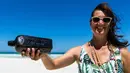 Tonya Illman memegang sebuah botol yang berisi pesan berusia hampir 132 tahun, yang dia temukan di dekat Pulau Wedge, sekitar 160 kilometer di utara Perth (7/3). Pesan tertua di dunia ini ditemukan pada bulan Januari. (AFP Photo/Kym Illman)