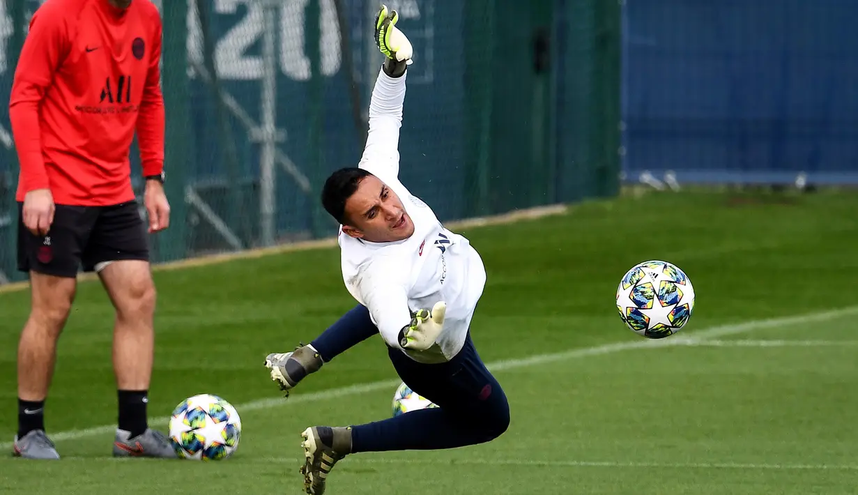 Kiper Paris Saint-Germain Keylor Navas melompat untuk menghalau bola saat sesi latihan jelang menghadapi Club Brugge pada laga Grup A Liga Champions di Saint-Germain-en-Laye, Paris, Prancis, Selasa (5/11/2019). (FRANCK FIFE/AFP)